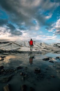 Man on top of mountain -Liberating Leadership - Leading and developing high performance