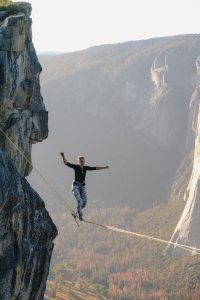 Woman tightroping across raven. Executive presence with Voice Ltd